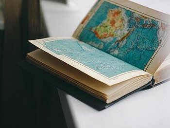 Offenes Buch. Im Buch ist eine Weltkarte abgebildet.